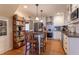 Well-equipped kitchen features white cabinetry, stainless steel appliances, and a charming breakfast bar with seating at 1010 Rosehill Ave, Durham, NC 27705