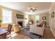 Comfortable living room featuring hardwood floors, a fireplace, and ample natural light at 1010 Rosehill Ave, Durham, NC 27705