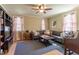 Cozy living room with a ceiling fan, a large sectional sofa, and abundant natural light from multiple windows at 1010 Rosehill Ave, Durham, NC 27705