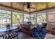 Screened patio with wood ceiling, fan, outdoor furniture, and views of the surrounding backyard at 1010 Rosehill Ave, Durham, NC 27705