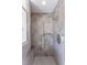 Shower featuring grey tiled walls with a built-in bench and dual shower heads at 1010 Rosehill Ave, Durham, NC 27705