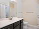 Bathroom with dark cabinets, white countertops, and a shower with a white curtain at 1013 Restoration Dr, Durham, NC 27703