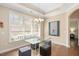 The dining area features a glass table, tufted chairs, and large sunny windows at 1013 Restoration Dr, Durham, NC 27703