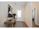 Inviting hallway with stylish decor, wood floors, and white trim leading to a bright bedroom at 1013 Restoration Dr, Durham, NC 27703