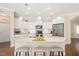 Bright kitchen with white cabinetry, granite countertops, stainless steel appliances, and a center island at 1013 Restoration Dr, Durham, NC 27703