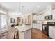 A kitchen showcasing a granite island, stainless steel appliances, and abundant white cabinetry at 1013 Restoration Dr, Durham, NC 27703