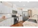 Kitchen features stainless steel appliances, granite countertops, and classic white cabinetry at 1013 Restoration Dr, Durham, NC 27703