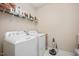 Bright laundry room with full size appliances, storage shelf and room for organization at 1013 Restoration Dr, Durham, NC 27703