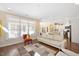Open-concept living area with hardwood floors, a white sofa, and views into the kitchen at 1013 Restoration Dr, Durham, NC 27703