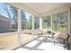 Bright sunroom with large windows offering scenic views of the wooded backyard at 1013 Restoration Dr, Durham, NC 27703