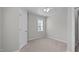 This bedroom has neutral carpeting, a window for natural light, and a closet for storage at 104 Stenness Ct, Apex, NC 27502