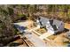 Aerial view of a neighborhood showcasing well-maintained homes with manicured lawns and mature trees on a sunny day at 104 Vinewood Pl, Holly Springs, NC 27540