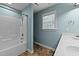 This bathroom has a shower and tub combination and a white vanity at 104 Vinewood Pl, Holly Springs, NC 27540