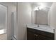 A bathroom featuring a modern vanity and a glass-enclosed shower space, reflecting a clean and functional design at 104 Vinewood Pl, Holly Springs, NC 27540