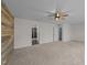 A bright bedroom offers neutral carpeting, a ceiling fan, and access to a bathroom at 104 Vinewood Pl, Holly Springs, NC 27540