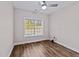 Minimal bedroom with neutral paint, ceiling fan and window views at 104 Vinewood Pl, Holly Springs, NC 27540