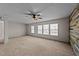 Spacious bedroom with a ceiling fan, windows and accent wall at 104 Vinewood Pl, Holly Springs, NC 27540