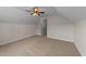 An upstairs bonus room includes a ceiling fan and neutral-colored carpet at 104 Vinewood Pl, Holly Springs, NC 27540