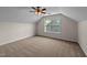 An upstairs bonus room includes a window and neutral-colored carpet at 104 Vinewood Pl, Holly Springs, NC 27540
