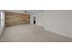 Spacious bedroom features a wood accent wall, ceiling fan, and neutral carpeting at 104 Vinewood Pl, Holly Springs, NC 27540