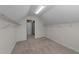 View into an attic closet with carpet, white walls and shelves at 104 Vinewood Pl, Holly Springs, NC 27540