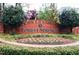 Community entrance sign, surrounded by lush landscaping, marking a welcoming and established neighborhood at 104 Vinewood Pl, Holly Springs, NC 27540