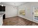 Cozy dining area with modern lighting, hardwood floors, and a door to the outside at 104 Vinewood Pl, Holly Springs, NC 27540