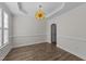 Dining area showcasing modern lighting, neutral walls, and wood-look flooring at 104 Vinewood Pl, Holly Springs, NC 27540