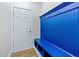 Entryway with a blue built-in bench, hooks, and cubbies, offering a practical and stylish storage solution at 104 Vinewood Pl, Holly Springs, NC 27540