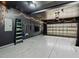 Spacious garage with ample storage and workspace, featuring a finished floor and overhead lighting at 104 Vinewood Pl, Holly Springs, NC 27540