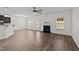 Spacious living room with hardwood floors, a fireplace, and ample natural light at 104 Vinewood Pl, Holly Springs, NC 27540