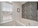 Soaking tub next to a window allowing natural light to fill the room at 1044 S Philwood Ct, Fuquay Varina, NC 27526