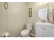 Cozy powder room with a white vanity and a decorative round mirror at 1044 S Philwood Ct, Fuquay Varina, NC 27526