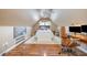 An upstairs bedroom with a desk, modern chair and light wood floors at 1044 S Philwood Ct, Fuquay Varina, NC 27526