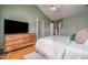 Bedroom with a TV and dresser, providing ample storage and entertainment at 1044 S Philwood Ct, Fuquay Varina, NC 27526