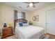 This cozy bedroom features hardwood floors, blue accents, and a ceiling fan at 1044 S Philwood Ct, Fuquay Varina, NC 27526