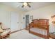 Bright Bedroom with wood crib, ceiling fan, white doors, and neutral walls at 1044 S Philwood Ct, Fuquay Varina, NC 27526