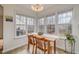 Sunlit dining area showcasing a wood table and chairs with backyard views at 1044 S Philwood Ct, Fuquay Varina, NC 27526