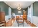 Spacious dining room featuring wood floors, a white and green wall, and arched entryway at 1044 S Philwood Ct, Fuquay Varina, NC 27526