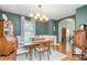 Elegant dining room with a wooden table, decorative lighting fixture, and view to living area at 1044 S Philwood Ct, Fuquay Varina, NC 27526