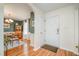 Inviting foyer leading into dining room, featuring wood floors and white door at 1044 S Philwood Ct, Fuquay Varina, NC 27526