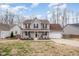 Charming two-story home with a welcoming front porch, beautiful landscaping, and an attached two-car garage at 1044 S Philwood Ct, Fuquay Varina, NC 27526