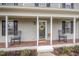 Charming front porch with rocking chairs and seasonal decor at 1044 S Philwood Ct, Fuquay Varina, NC 27526