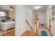 Hallway with wooden staircase and patterned rug leading to bedrooms at 1044 S Philwood Ct, Fuquay Varina, NC 27526