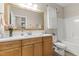 Charming bathroom featuring wood vanity with a large mirror and a shower-tub combination at 105 Oak Ridge Rd, Franklinton, NC 27525