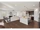 Open-concept living space featuring a kitchen island and a cozy living room with a fireplace at 106 Filigree Way, Durham, NC 27713