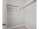 A walk-in closet featuring neutral carpet and white shelving at 106 Filigree Way, Durham, NC 27713