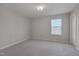 Bright bedroom featuring neutral carpet, fresh light-gray paint, and a window with privacy blinds at 106 Florence Pl, Morrisville, NC 27560