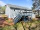 A backyard features a deck with stairs to the lawn at 117 Holly Mountain Rd, Holly Springs, NC 27540