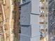 Aerial shot of gray roofed townhomes with sidewalks, landscaping and parking at 1207 Corkery Ridge Ct, Cary, NC 27519